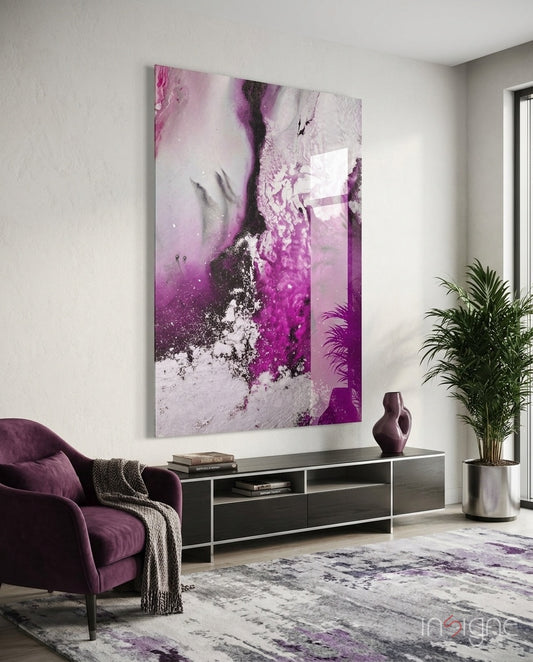 Colors of Abstraction glass wall art displayed above a black TV console in a soft white-walled lounge with plum velvet armchair and palm vase