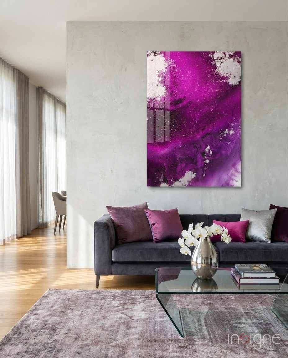 Colors of Abstraction glass wall art displayed above a charcoal velvet sofa in a soft white-plaster lounge with magenta and silver pillows