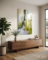 Colors of Abstraction glass wall art displayed above a walnut credenza in a soft white-plaster hallway with fiddle leaf fig and stoneware vase