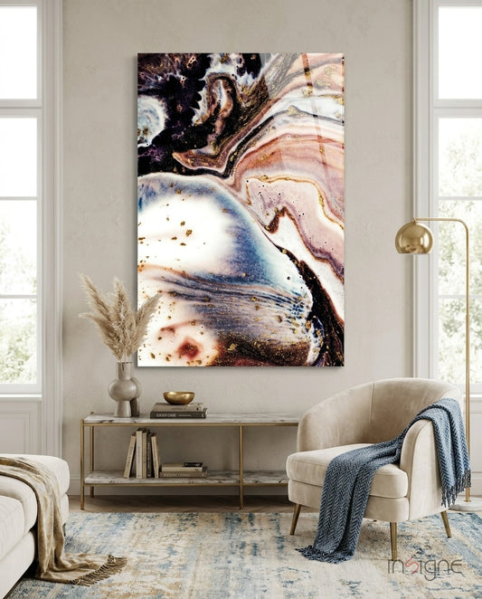 Abstract glass wall art displayed above a marble console in a soft cream-plaster lounge with bouclé armchair and pampas vase
