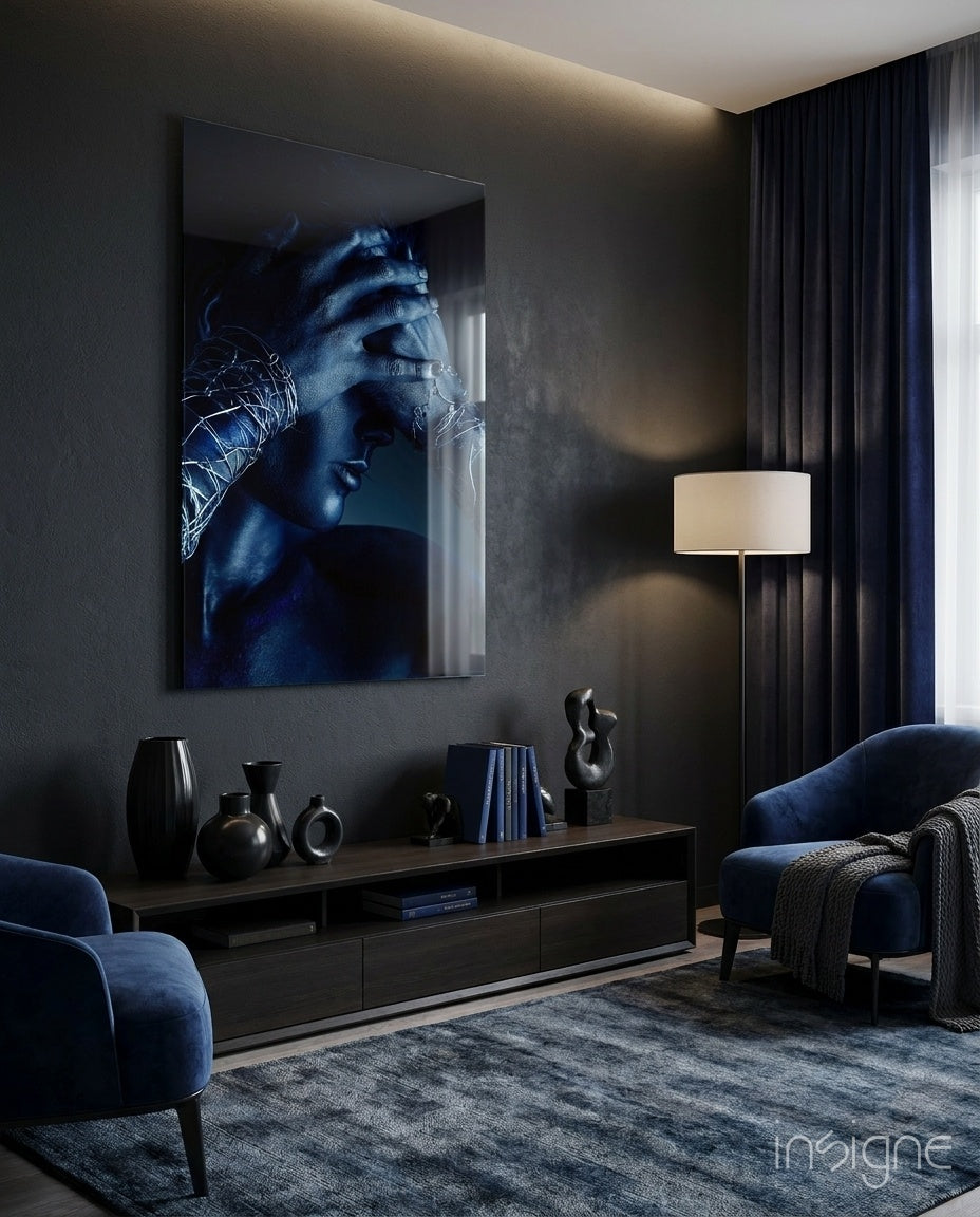 Deep Thought glass wall art displayed beside a navy velvet armchair in a moody charcoal-walled lounge with low credenza and floor lamp