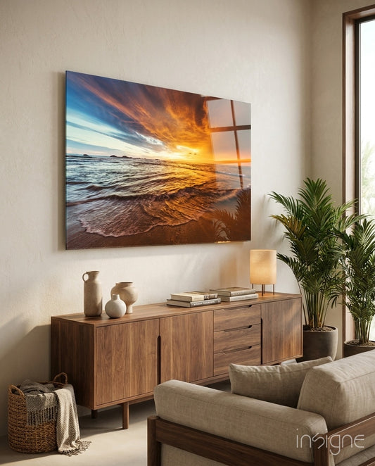 Sunset glass wall art displayed above a walnut credenza in a soft white-plaster lounge with linen sofa and stoneware vases