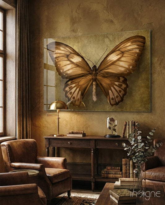 Butterfly glass wall art displayed above an antique wood console in a warm sepia-plaster study with leather armchair and aged books
