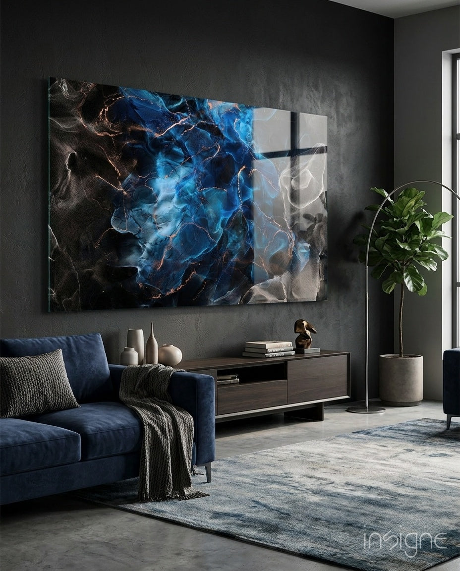 Energy glass wall art displayed above a navy velvet sectional in a moody charcoal-walled lounge with concrete floor and fiddle leaf fig
