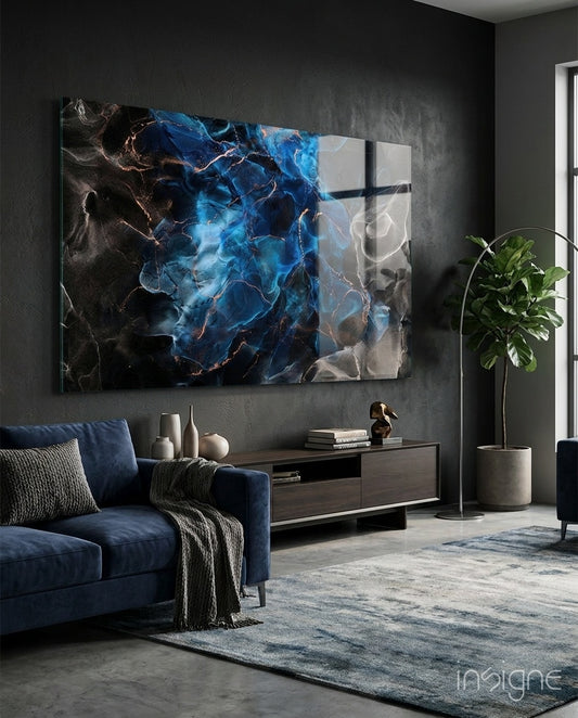 Energy glass wall art displayed above a navy velvet sectional in a moody charcoal-walled lounge with concrete floor and fiddle leaf fig
