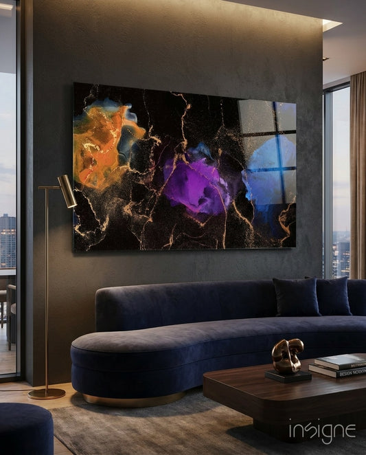 Energy glass wall art displayed above a navy velvet curved sofa in a moody charcoal-walled lounge with brass floor lamp and sculptural objet
