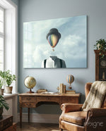 Balloon Heads glass wall art displayed above an antique wood desk in a soft blue-walled study with leather wing chair and antique globe