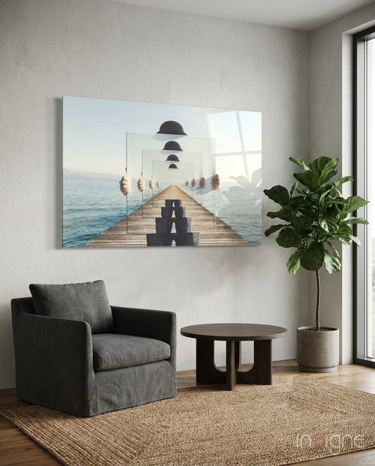 Loop glass wall art displayed above a charcoal linen armchair in a soft white-plaster lounge with round wood coffee table and fiddle leaf fig