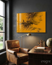 Woman Bird glass wall art displayed above an antique wood desk in a charcoal-walled study with cognac leather chair and brass lamp