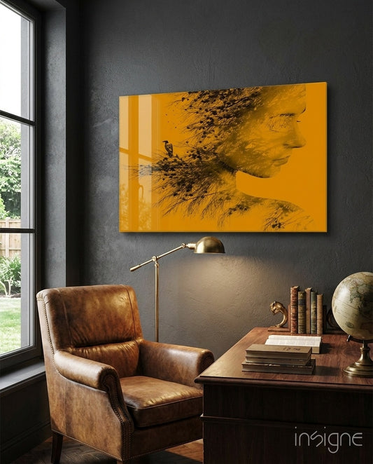 Woman Bird glass wall art displayed above an antique wood desk in a charcoal-walled study with cognac leather chair and brass lamp