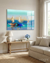 Sailboat glass wall art displayed above a wood console in a soft cream-plaster lounge with linen sofa and hydrangea arrangement