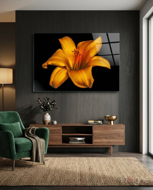 Lily glass wall art displayed above a walnut TV console in a moody charcoal-walled lounge with green velvet armchair and stoneware vase
