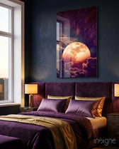 Moon glass wall art displayed above a plum velvet headboard in a navy-walled bedroom with brass lamp and gold satin pillows
