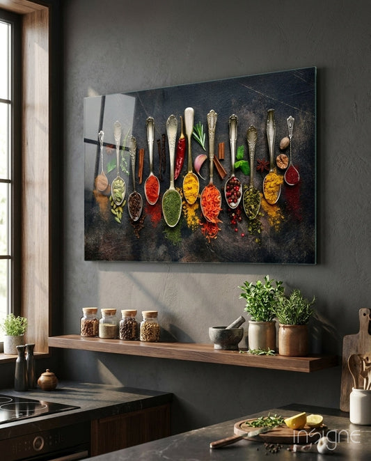 Spices glass wall art displayed above a wood floating shelf in a warm charcoal-walled kitchen with potted herbs and stone counter