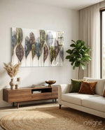 Feathers glass wall art displayed above a walnut credenza in a soft ivory-plaster lounge with cream sofa and pampas vase