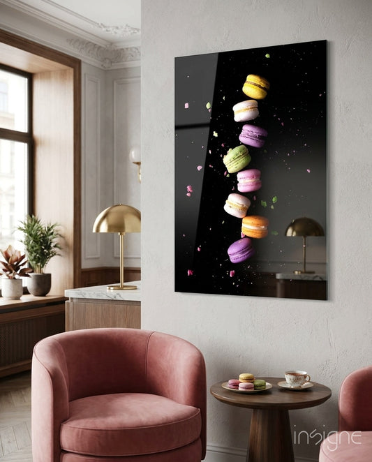 Macarons glass wall art displayed beside a rose velvet armchair in a soft cream-paneled lounge with brass dome lamps and tea service