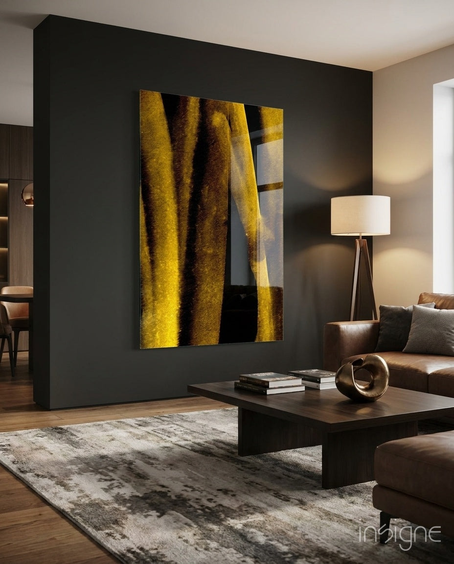Yellow Story glass wall art displayed above a dark wood coffee table in a moody charcoal-walled lounge with cognac sectional and tripod lamp