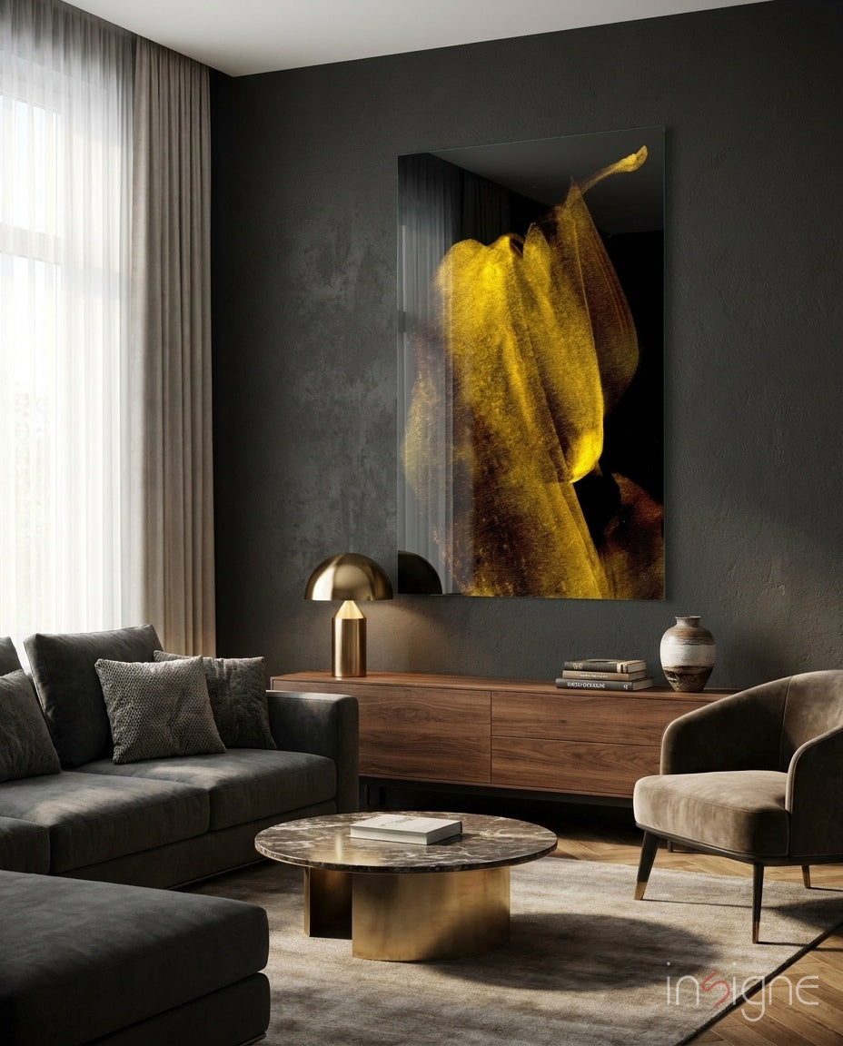 Yellow Story glass wall art displayed above a walnut credenza in a moody charcoal-walled lounge with cream sectional and brass dome lamp