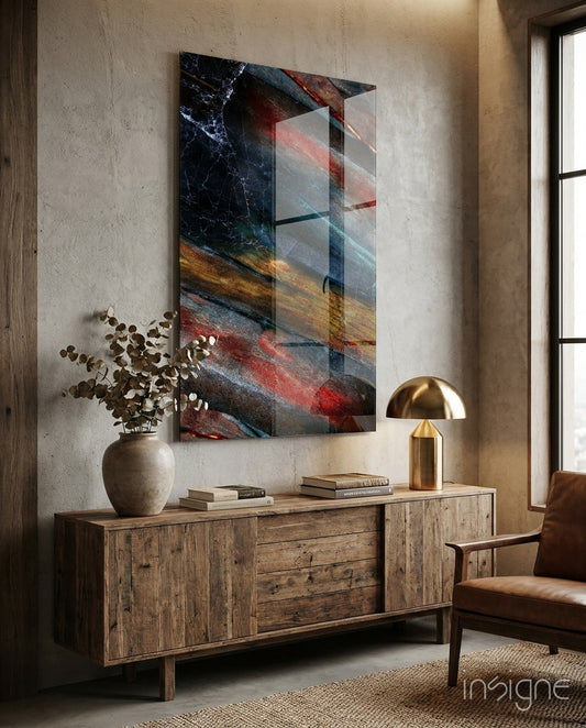 Abstract glass wall art displayed above a reclaimed wood credenza in a soft concrete-walled lounge with cognac armchair and dried eucalyptus