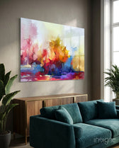 Abstract Trees glass wall art displayed above a brass-trim console in a soft white-plaster lounge with teal velvet sofa and traveler palm