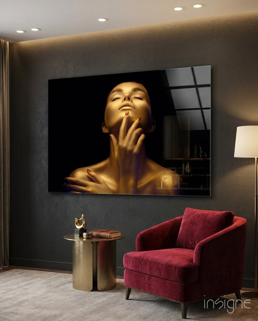 Gold Woman glass wall art displayed beside a crimson velvet armchair in a moody charcoal-walled study with brass side table and floor lamp
