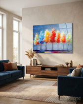 Drawing Trees glass wall art displayed above a walnut credenza in a soft cream-plaster lounge with two navy velvet sofas and warm rug