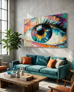 Pupil glass wall art displayed above a teal velvet sofa in a soft concrete-walled lounge with reclaimed wood coffee table and fiddle leaf fig