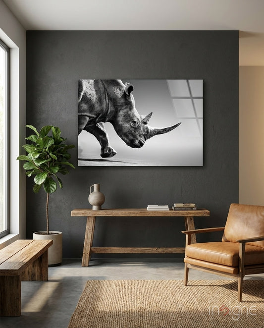Black Rhino glass wall art displayed above a rustic wood console in a moody charcoal-walled hallway with cognac armchair and fiddle leaf fig