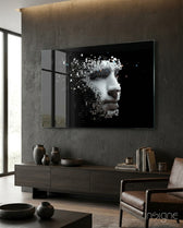 Being Human glass wall art displayed above a dark wood credenza in a moody concrete-walled lounge with leather armchair and stoneware vases