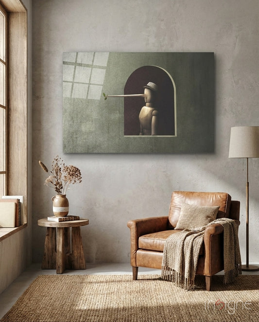 Pinocchio glass wall art displayed above a cognac leather armchair in a soft sage-plaster lounge with wood side table and dried botanicals