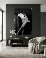Flower glass wall art displayed above a dark wood credenza in a moody charcoal-walled lounge with bouclé swivel chair and orchid arrangement