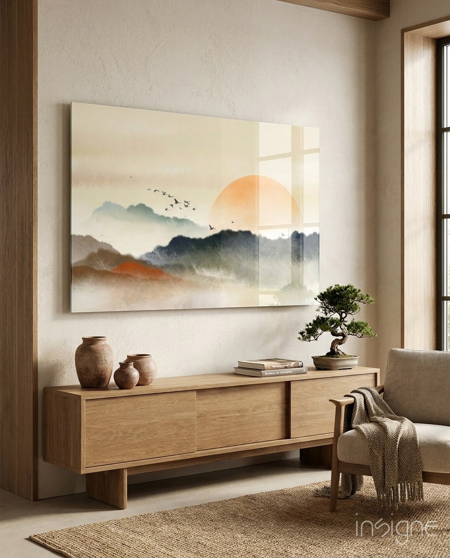 Abstract Landscape glass wall art displayed above a wood credenza in a soft cream-plaster lounge with linen armchair and bonsai