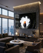Astronaut glass wall art displayed above a stone-clad TV niche in a moody penthouse lounge with brown velvet sofa and city view