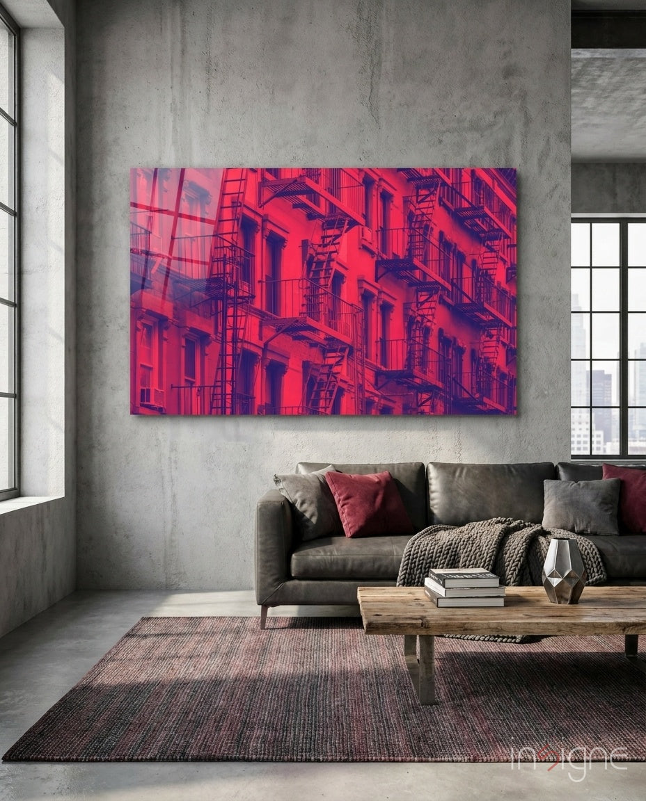 Windows glass wall art displayed above a charcoal leather sectional in a concrete-walled industrial lounge with reclaimed wood coffee table and crimson pillows