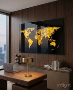World Map glass wall art displayed above a wood-paneled desk in a walnut-clad office with brass dome lamp and laptop