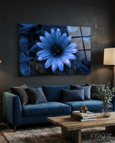 Flower glass wall art displayed above a navy velvet sofa in a moody charcoal-walled lounge with reclaimed wood coffee table and eucalyptus stems