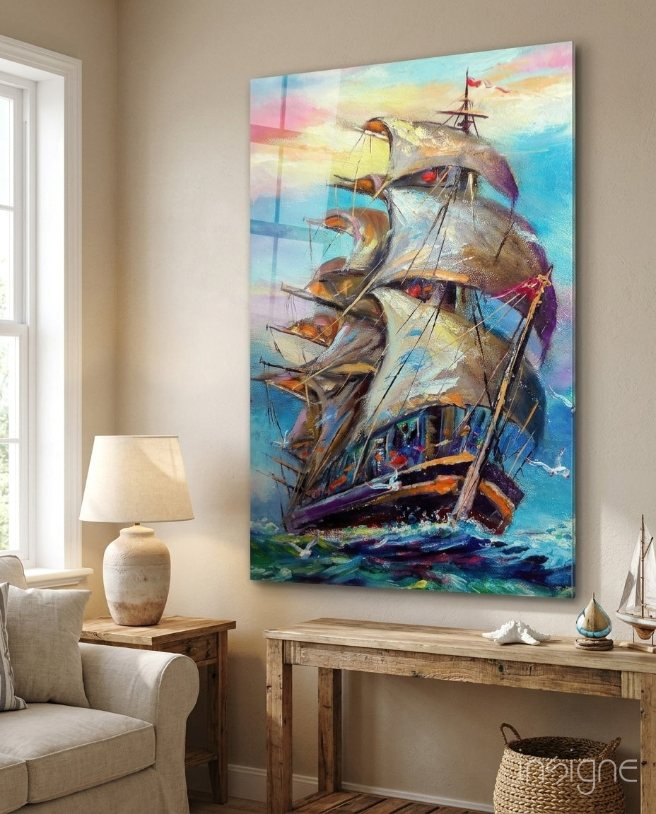Sailboat glass wall art displayed above a reclaimed wood console in a soft cream-walled lounge with linen armchair and seashell decor