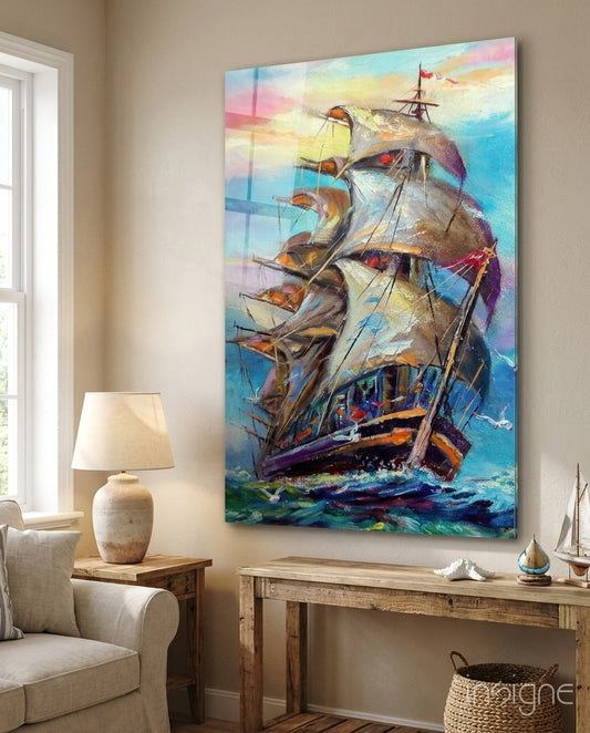 Sailboat glass wall art displayed above a reclaimed wood console in a soft cream-walled lounge with linen armchair and seashell decor