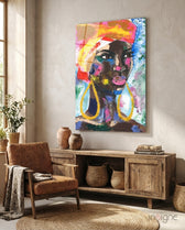 Woman with Earrings glass wall art displayed above a reclaimed wood credenza in a soft cream-plaster lounge with cognac armchair and stoneware vases