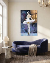 Ballerina glass wall art displayed beside a navy velvet sofa in a soft white-paneled lounge with marble side table and chandelier