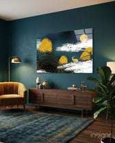 Abstraction glass wall art displayed above a walnut credenza in a teal-walled lounge with mustard velvet armchair and fiddle leaf fig