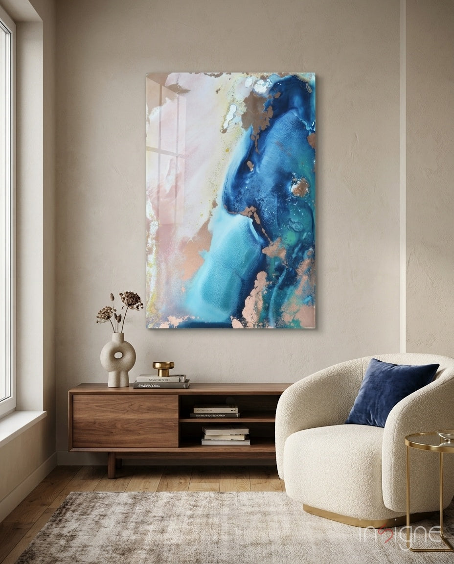 Abstraction glass wall art displayed above a walnut TV console in a soft cream-plaster lounge with bouclé swivel chair and donut vase