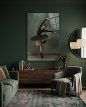 Ballerina glass wall art displayed above a walnut credenza in a deep emerald-walled lounge with charcoal velvet armchair and round mirror