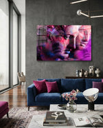 Statues glass wall art displayed above a navy velvet sofa in a moody concrete-walled lounge with magenta velvet pillows and marble coffee table