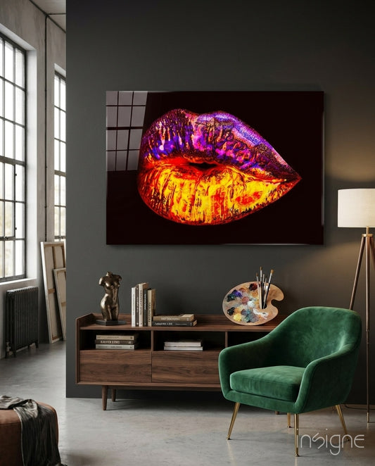 Lip glass wall art displayed above a walnut credenza in a moody charcoal-walled artist studio with green velvet armchair and paint palette