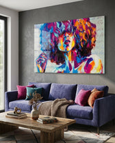 Bohemian glass wall art displayed above a violet velvet sofa in a charcoal-walled lounge with magenta and rust pillows and reclaimed wood coffee table
