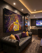 Kobe Bryant glass wall art displayed above a black tufted leather sofa in a man cave with basketball shelf and brushed-brass sconces