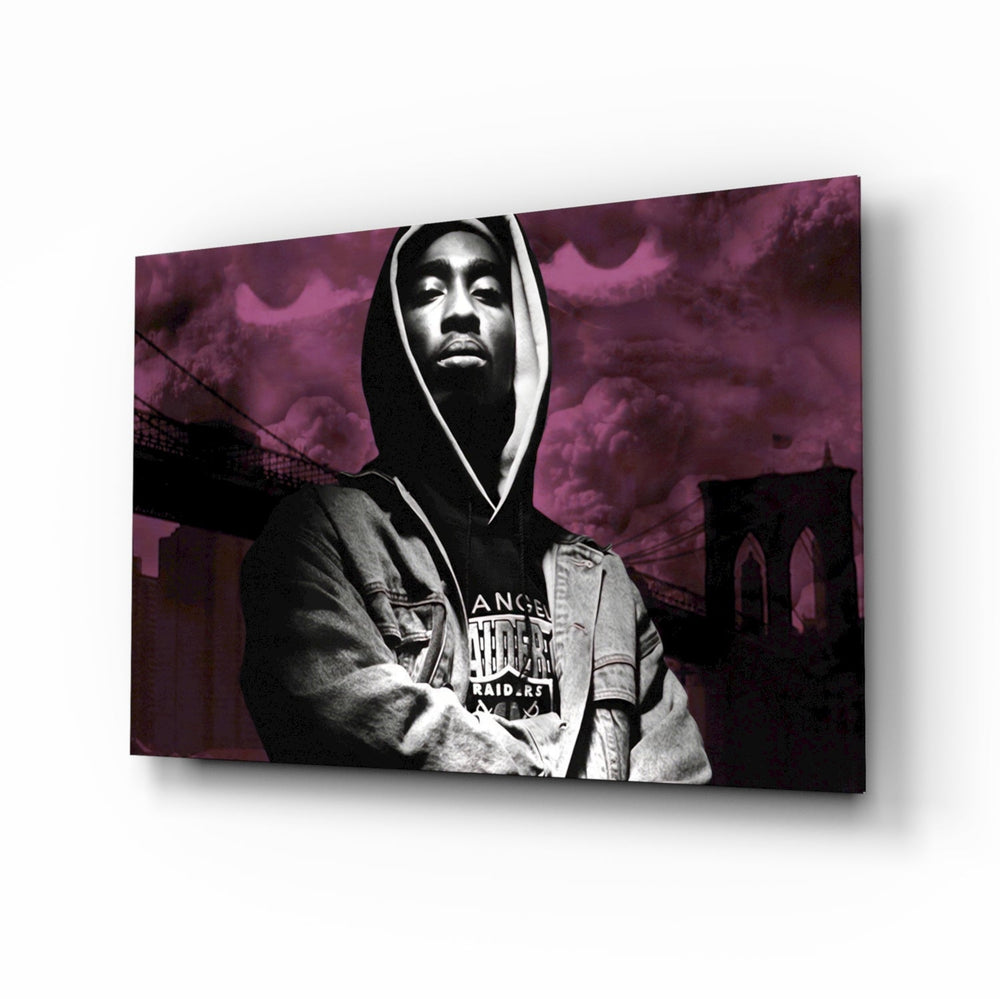 Tupac Shakur glass wall art displayed above a black leather sectional in a moody music room with reclaimed-wood console and brass arc lamp