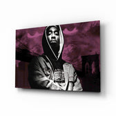 Tupac Shakur glass wall art displayed above a black leather sectional in a moody music room with reclaimed-wood console and brass arc lamp
