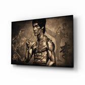 Bruce Lee glass wall art displayed above a leather chesterfield in a moody man cave with reclaimed-wood console and brass arc lamp